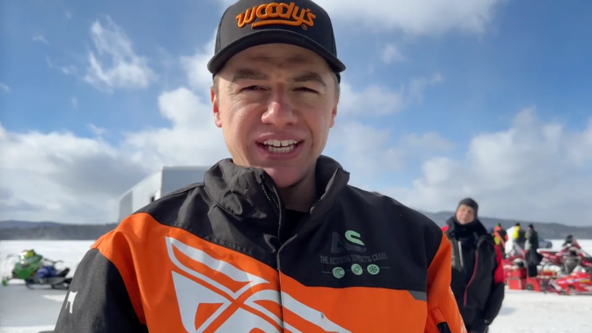 TJ Leach at a snowmobile race in his orange riding gear